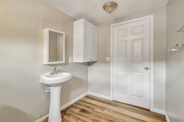 bathroom featuring baseboards and wood finished floors