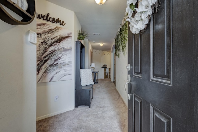 corridor featuring visible vents and light colored carpet