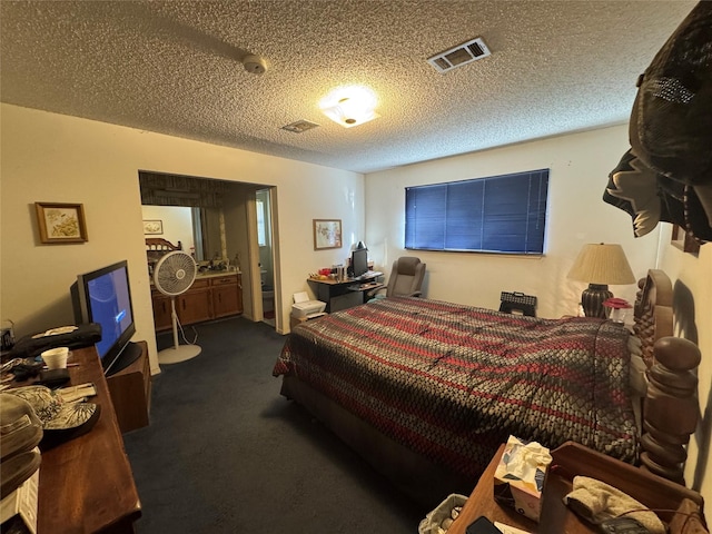 bedroom with visible vents, dark colored carpet, and a textured ceiling