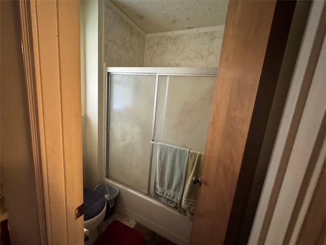 bathroom with enclosed tub / shower combo, a textured ceiling, and toilet