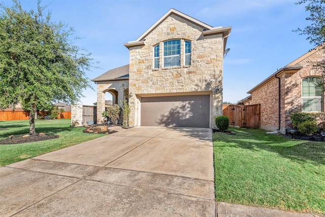 french provincial home featuring stone siding, concrete driveway, a front yard, and fence