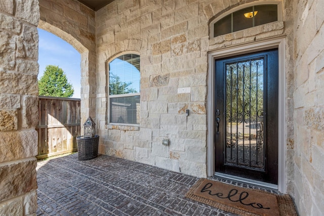 entrance to property featuring stone siding