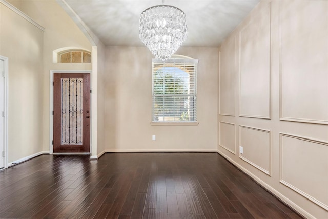 foyer with baseboards, dark wood-style flooring, and a notable chandelier