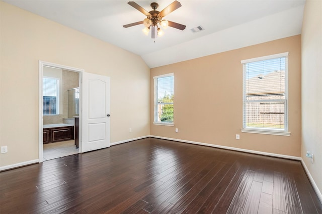 spare room with light wood finished floors, baseboards, visible vents, lofted ceiling, and ceiling fan