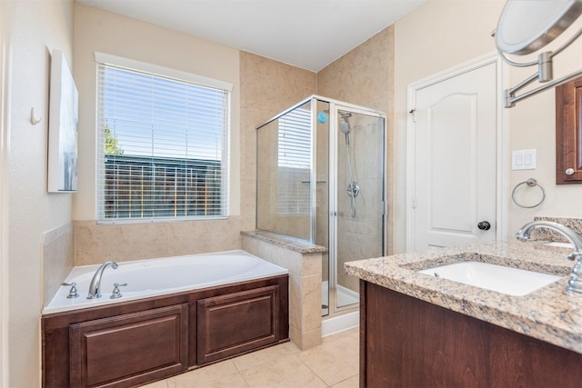 bathroom with a bath, a shower stall, vanity, and tile patterned floors