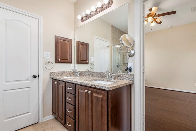 full bath featuring double vanity, visible vents, ceiling fan, a sink, and tile patterned flooring