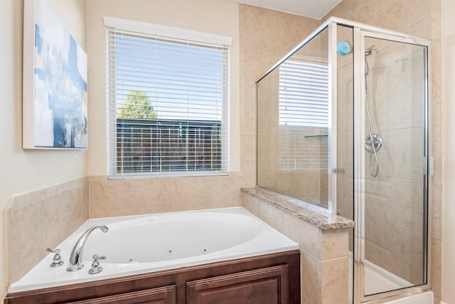 bathroom with a jetted tub and a stall shower