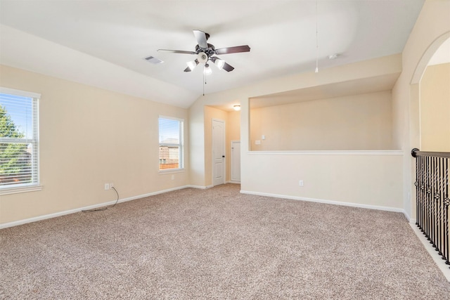 unfurnished room with baseboards, carpet flooring, lofted ceiling, and a healthy amount of sunlight