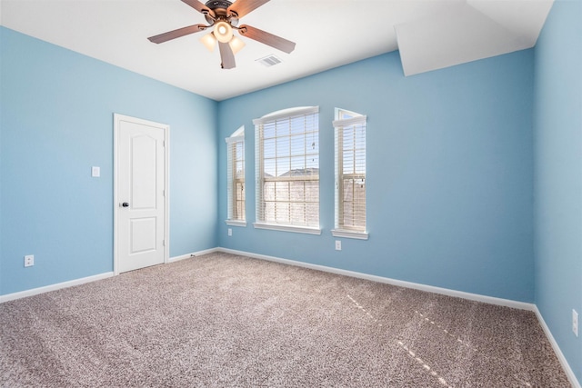 unfurnished room with a ceiling fan, visible vents, baseboards, and carpet flooring