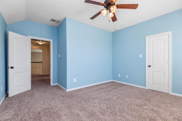 unfurnished bedroom with baseboards, arched walkways, visible vents, and light colored carpet