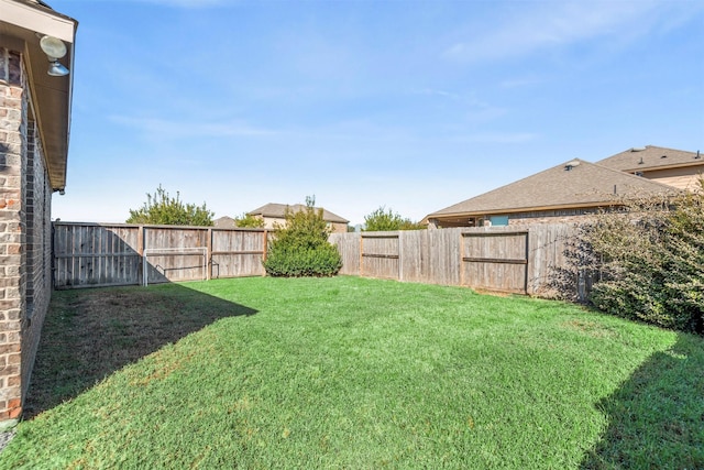 view of yard with a fenced backyard