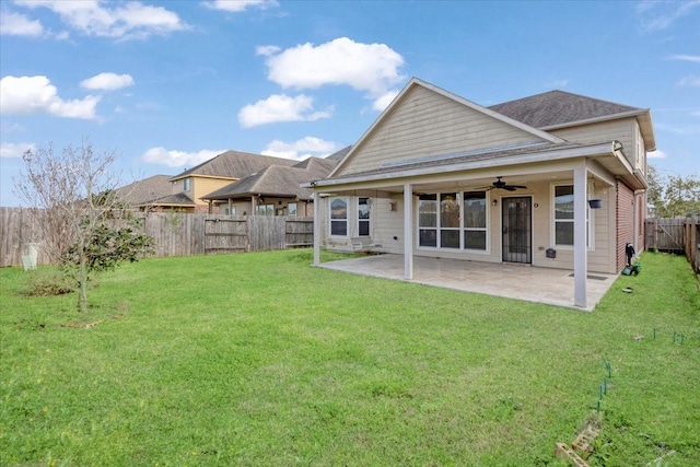 back of property featuring a fenced backyard, a lawn, a ceiling fan, and a patio