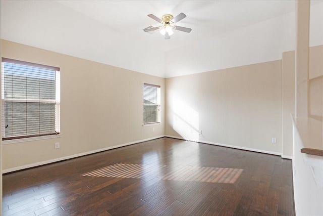 unfurnished room featuring vaulted ceiling, baseboards, dark wood finished floors, and a ceiling fan