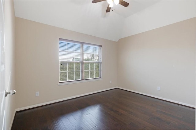 empty room featuring lofted ceiling, baseboards, a ceiling fan, and dark wood-style flooring