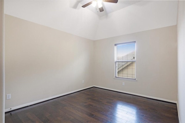 empty room with lofted ceiling, ceiling fan, baseboards, and dark wood finished floors