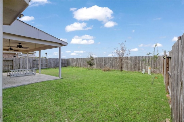 view of yard featuring a patio area, a fenced backyard, and a ceiling fan