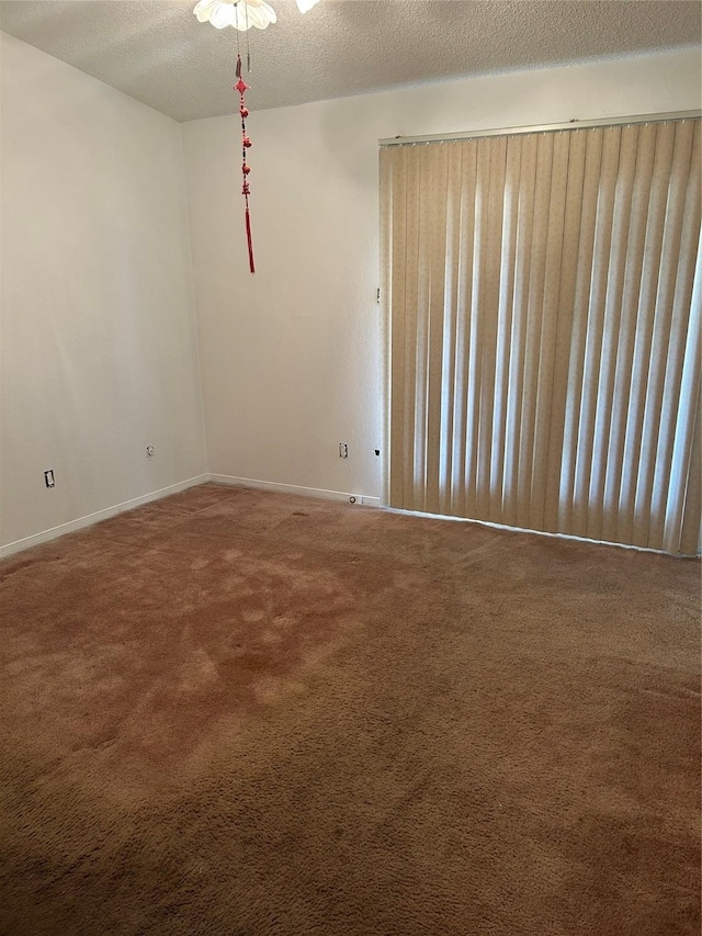 3600 Jeanetta St Unit 1202, Houston, TX 77063 - carpeted empty room featuring baseboards and a textured ceiling