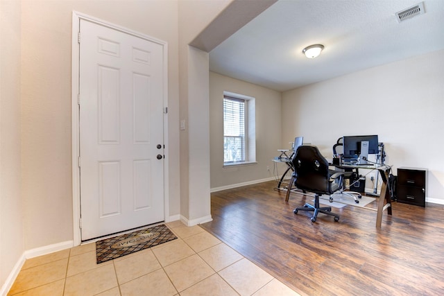 office area featuring visible vents, baseboards, and wood finished floors