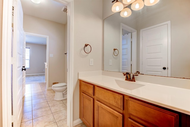 bathroom with visible vents, baseboards, toilet, tile patterned floors, and vanity