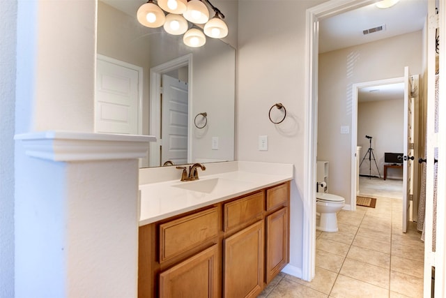 bathroom with baseboards, visible vents, toilet, tile patterned floors, and vanity