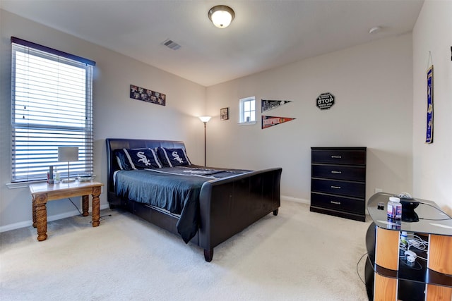 bedroom featuring light colored carpet, visible vents, and baseboards