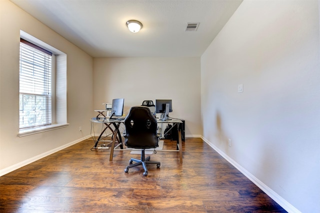 office space featuring wood finished floors, visible vents, and baseboards