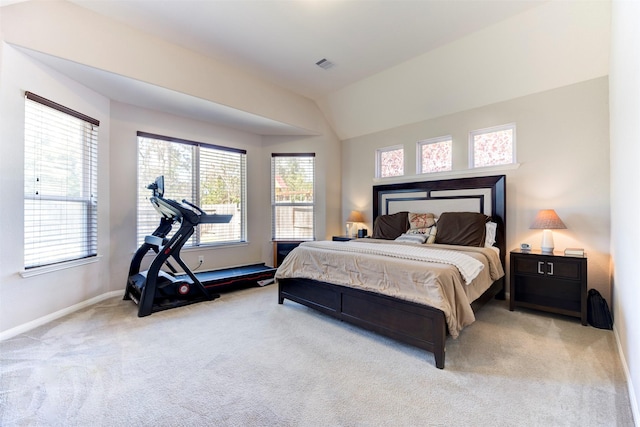 bedroom with carpet, visible vents, vaulted ceiling, and baseboards