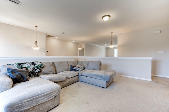 carpeted living room with visible vents and baseboards