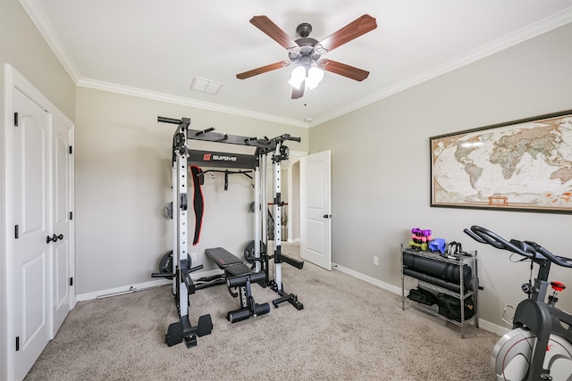 workout area featuring a ceiling fan, baseboards, crown molding, and light colored carpet