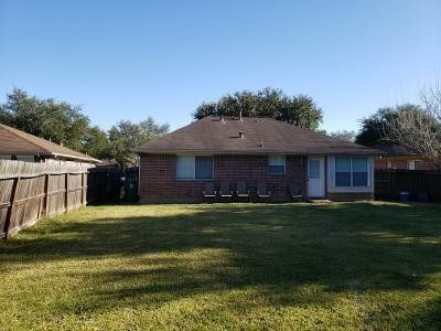 back of house featuring a lawn and a fenced backyard