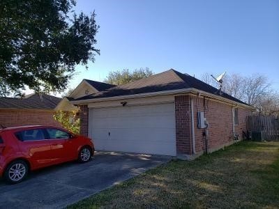 view of home's exterior with brick siding, driveway, and an attached garage