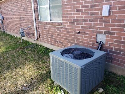 exterior details with brick siding, central AC unit, and gas meter