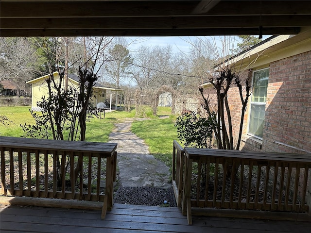 wooden terrace featuring a yard