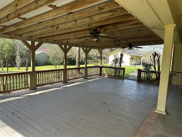 wooden deck with a ceiling fan