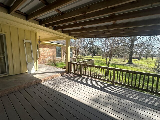 wooden deck featuring a yard