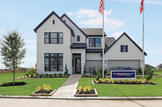 view of front of property with a garage and a front lawn