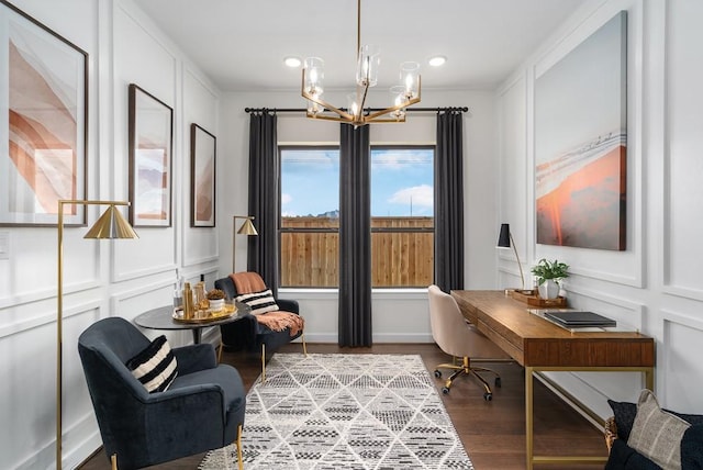 office featuring a notable chandelier, wood finished floors, and a decorative wall