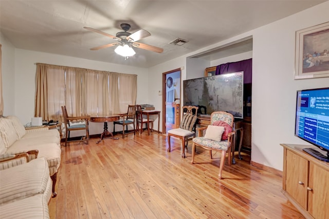 living area featuring a ceiling fan, visible vents, and light wood-style flooring