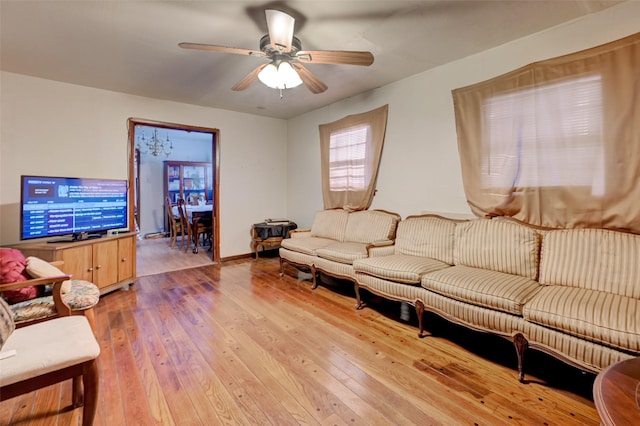 living area with light wood finished floors and ceiling fan