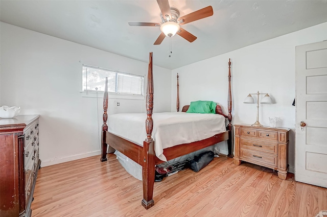 bedroom with light wood-style floors, ceiling fan, and baseboards