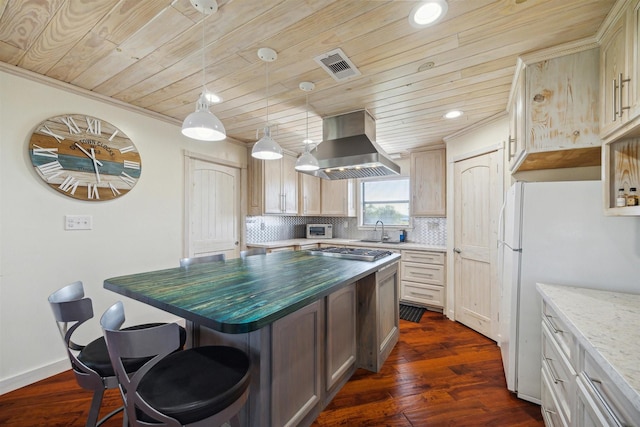 kitchen with a kitchen island, a sink, island exhaust hood, stainless steel gas cooktop, and backsplash