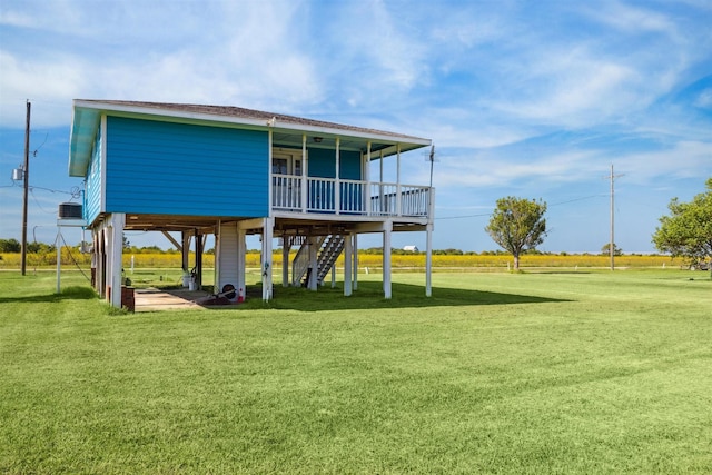 exterior space featuring stairs, a carport, and a lawn