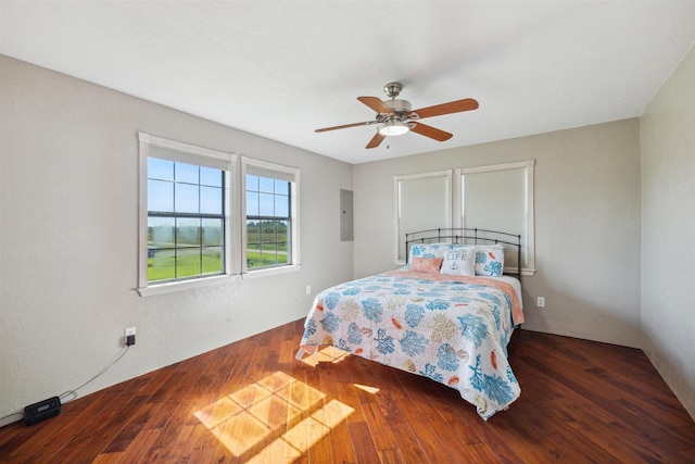 bedroom featuring dark wood-style flooring, electric panel, and ceiling fan