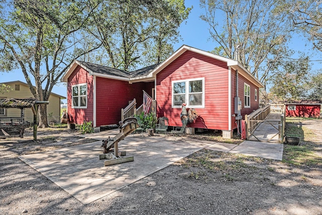 rear view of property with roof with shingles