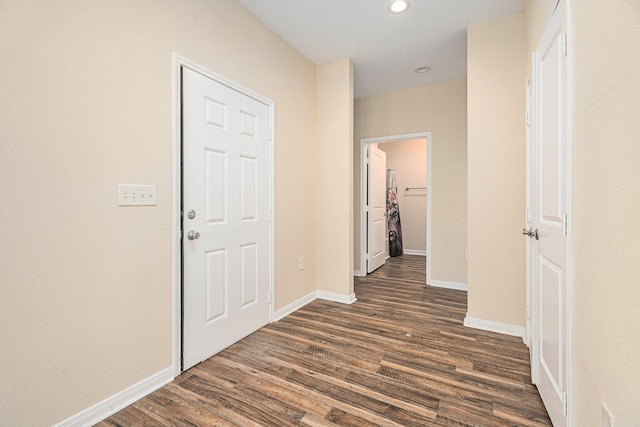 corridor with dark wood-style floors, recessed lighting, and baseboards