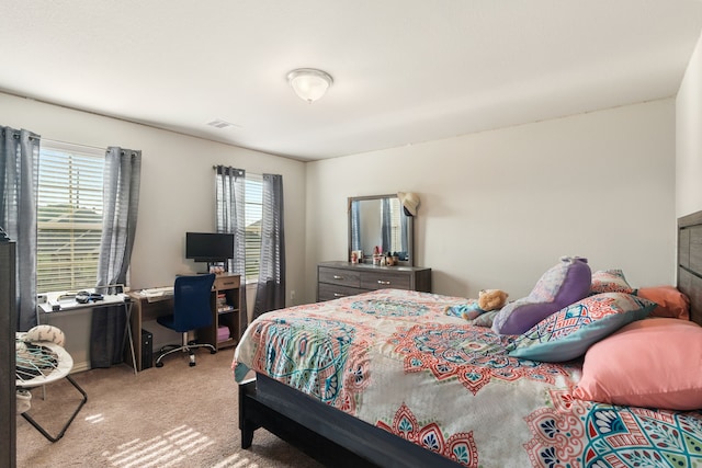 carpeted bedroom with multiple windows and visible vents