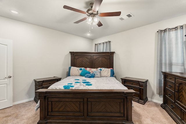 bedroom with light colored carpet, visible vents, and baseboards