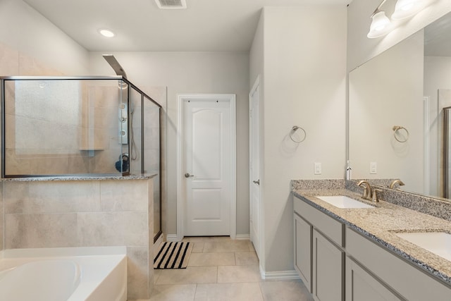 bathroom featuring a sink, a bath, a stall shower, and tile patterned flooring