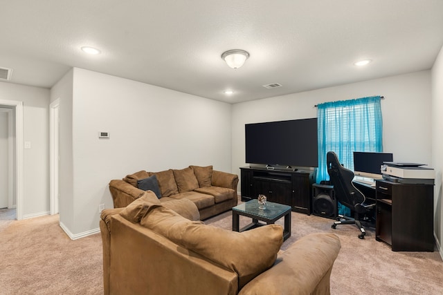 living area with recessed lighting, light colored carpet, visible vents, and baseboards