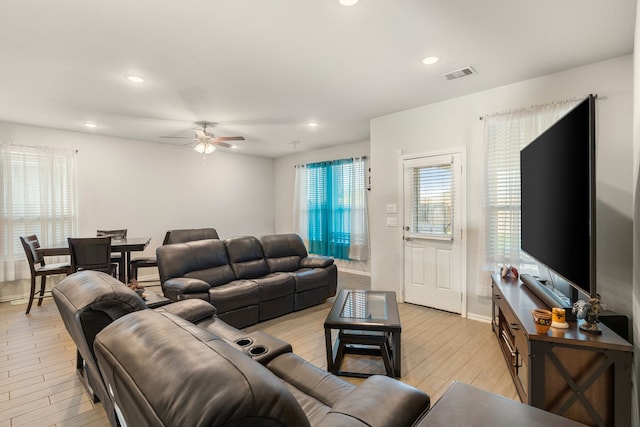 living area featuring visible vents, recessed lighting, light wood-type flooring, and a ceiling fan